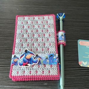 Eeyore themed note pad case with pad and pen.